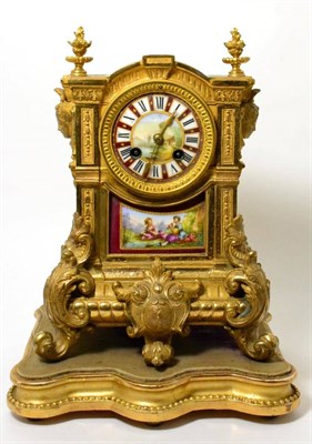 Lot 240 - A gilt metal porcelain mounted striking mantel clock with garniture, circa 1890, urn finial...