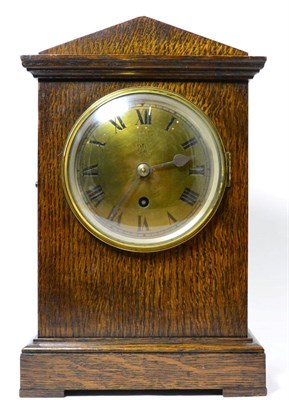 Lot 243 - An oak RAF mantel timepiece, circa 1940, architectural pediment, 5-1/4-inch dial with Roman...