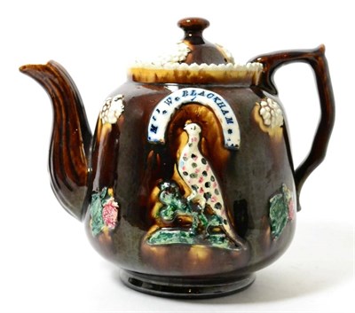 Lot 246 - A Measham bargeware teapot and cover, inscribed M W BLACKHAM, PETERBOROUGH 1873, 19cm high