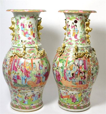 Lot 269 - A pair of Cantonese baluster vases, 19th century, painted in famille rose enamels with figures on a