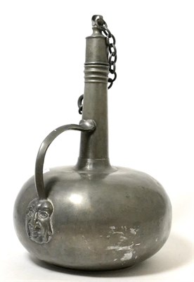 Lot 272 - An 18th century French pewter wine flask and stopper, of onion form with loop handle and mask...