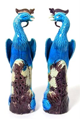 Lot 273 - A pair of Chinese porcelain phoenix, late 19th century, decorated in blue and aubergine glazes,...