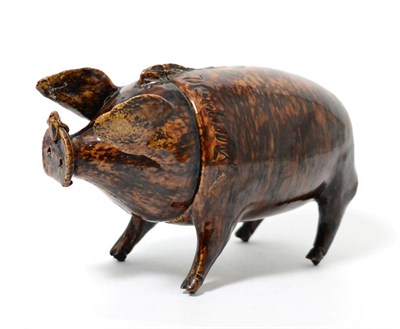 Lot 279 - A treacle glazed tobacco jar and cover, circa 1830, modelled as a standing pig, indistinctly...