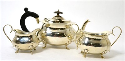 Lot 282 - A George V silver three piece tea service, Birmingham 1911, of ovoid form on fluted feet,...