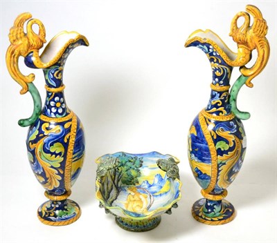 Lot 286 - A pair of Italian maiolica ewers in Renaissance style, painted with classical figures on a blue...