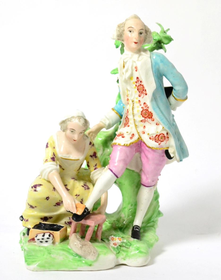 Lot 425 - A Derby porcelain figure group of a shoe black, circa 1780, as a gentleman standing, his one...