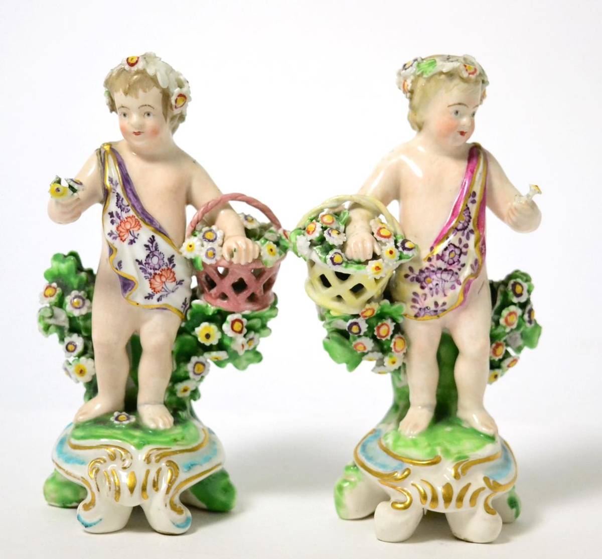 Lot 440 - A pair of Derby porcelain figures of putti, circa 1780, as flower attendants holding baskets,...