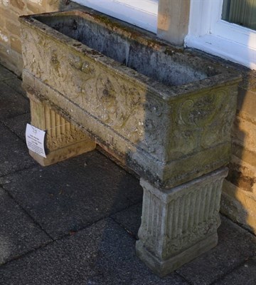 Lot 1162 - A composition garden rectangular planter, decorated with scrolling flowers and fruit, raised on...