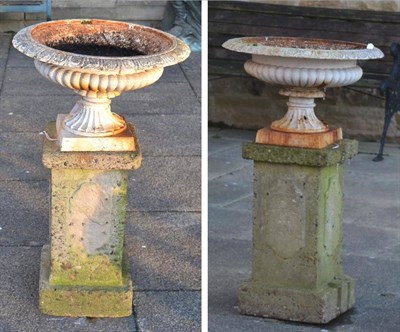 Lot 1167 - A pair of Victorian cast iron campana shaped garden urns, with egg and dart decorated rims and...