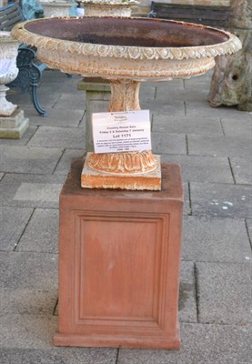 Lot 1171 - A Victorian cast iron garden urn, of large proportions, with an egg and dart border, raised on...