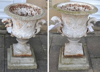 Lot 1173 - A pair of white painted cast iron campana shaped garden urns with C scroll handles terminating with