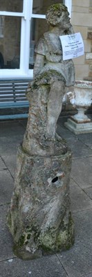 Lot 1175 - A weathered composition garden figure modelled as a lady wearing a dress leaning against a tree...