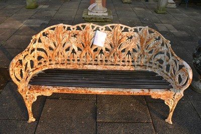 Lot 1178 - A Victorian cast iron and white painted garden seat with five wooden slats, 157cm wide