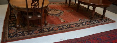 Lot 1187 - Sultanabad carpet, West Iran, the plain soft strawberry field centred by an indigo and ivory...