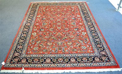 Lot 1193 - Saroukh design Carpet, the terracotta field with an allover design of scrolling vines enclosed...