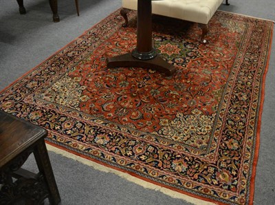 Lot 1194 - Saroukh Carpet, West Iran, the terracotta field of scrolling vines around a pole medallion...