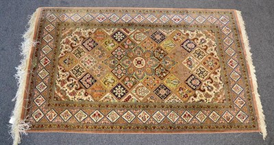 Lot 1196 - A Ghom silk Rug, Central Iran, the diamond lattice field with central flowerhead medallion...