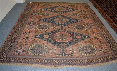 Lot 1206 - Causasian Soumakh, the soft terracotta field with three indigo medallions flanked by hexagons...