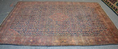 Lot 1210 - Feraghann carpet, West Iran, the deep indigo field of 'gul henna' design around a stepped medallion