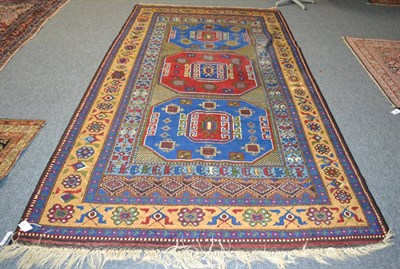 Lot 1214 - Taspinar rug, Anatolia, the field with three octagons enclosed by stylised flowerhead borders,...