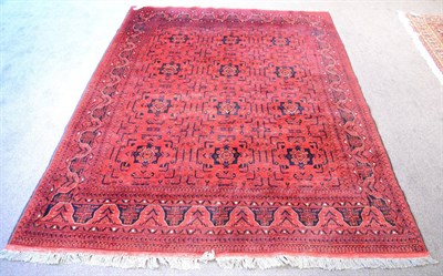 Lot 1226 - Turkmen Rug, North Afghanistan, the compartmentalised madder field of stylised flowerheads enclosed