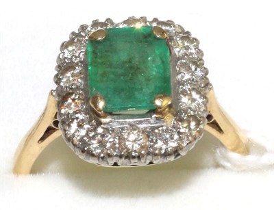 Lot 22 - An emerald and diamond cluster ring, an emerald-cut emerald in a yellow claw setting, within a...