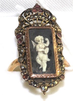 Lot 35 - A garnet and marcasite set mourning ring, with a central painted panel depicting a putti with a...