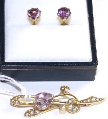 Lot 40 - An Art Nouveau amethyst and seed pearl brooch, an oval cut amethyst in a yellow milgrain setting to