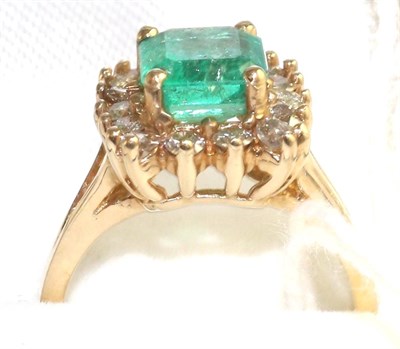 Lot 54 - An emerald and diamond cluster ring, an emerald-cut emerald within a border of round brilliant...