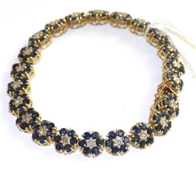 Lot 57 - A sapphire and diamond bracelet, of flowerhead clusters, each with a round brilliant cut...