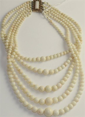 Lot 58 - A coral bead necklace, five strands of graduated bleached coral beads knotted to a coral set...