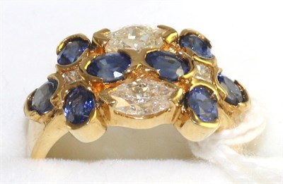 Lot 65 - A sapphire and diamond cluster ring, eight oval cut sapphires with two marquise cut diamonds...