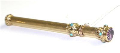 Lot 66 - A propelling pencil, of telescopic form the top inset with a round cut amethyst in a yellow...