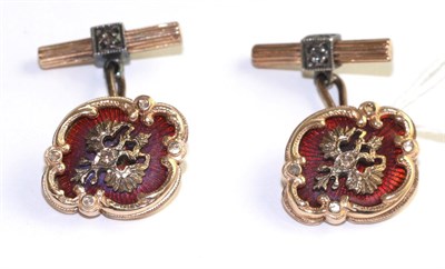 Lot 69 - A pair of cufflinks, with a double headed eagle motif, overlaid in red enamel, within a...