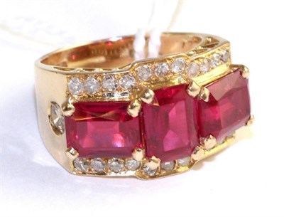 Lot 78 - A synthetic ruby and diamond ring, three emerald cut synthetic rubies in yellow claw setting within