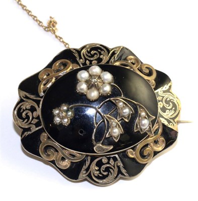 Lot 86 - A Victorian black enamel, split pearl and diamond mourning brooch, with a central floral motif...