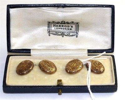 Lot 99 - A pair of double oval cufflinks, with chased scroll decoration, bar linked, cased by Harrod's