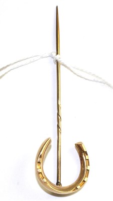 Lot 103 - A horseshoe stick pin, measures 2.1cm by 7.8cm