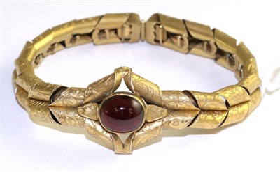 Lot 106 - A Victorian carbuncle garnet bracelet, an oval garnet in a yellow rubbed over setting within a...