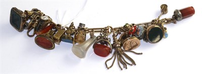 Lot 109 - A charm bracelet, a fancy link bracelet suspending nine various hard stone seals and fobs and...