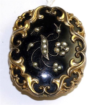 Lot 111 - A Victorian black enamel, split pearl and diamond mourning brooch, with a central floral motif...