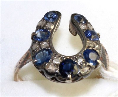 Lot 112 - A sapphire and diamond horseshoe ring, round and oval cut sapphires spaced by pairs of rose cut...