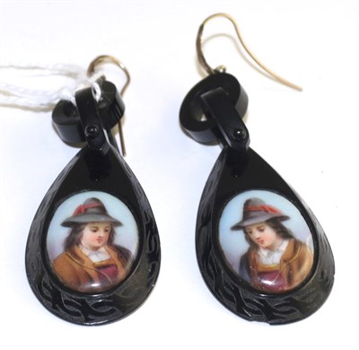 Lot 115 - A pair of jet earrings, each set with an oval portrait of a man to oval jet frames with carved...