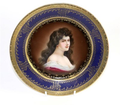 Lot 140 - A Vienna style porcelain plate, circa 1900, painted with ";Amorosa";  within a blue and gilt...