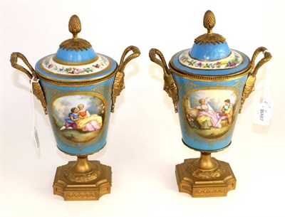 Lot 144 - A pair of gilt metal mounted Sevres style urn shape vases and covers, late 19th century,...