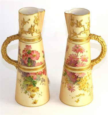 Lot 153 - A pair of Royal Worcester porcelain ewers, 1904, modelled with prunus and painted with flower...