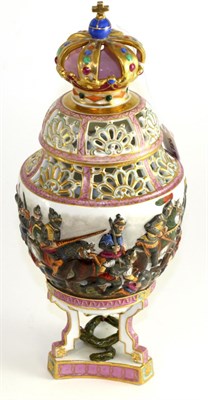 Lot 156 - A Capodimonte style pot pourri vase and cover, with crown finial moulded with a battle scene on...