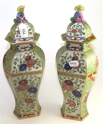 Lot 164 - A pair of Sampson of Paris hexagonal baluster vases and covers painted in Worcester style with...