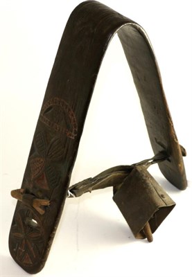 Lot 166 - A Swiss carved wood yoke and cow bell