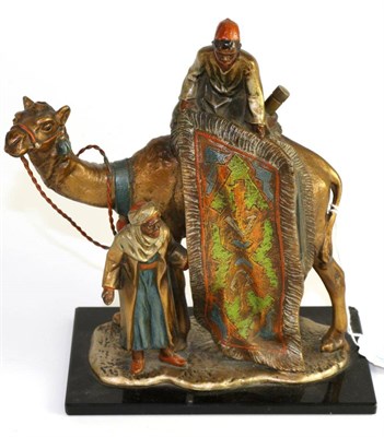 Lot 172 - A cold painted spelter table lighter, modelled as a carpet seller sitting on a camel holding a rug